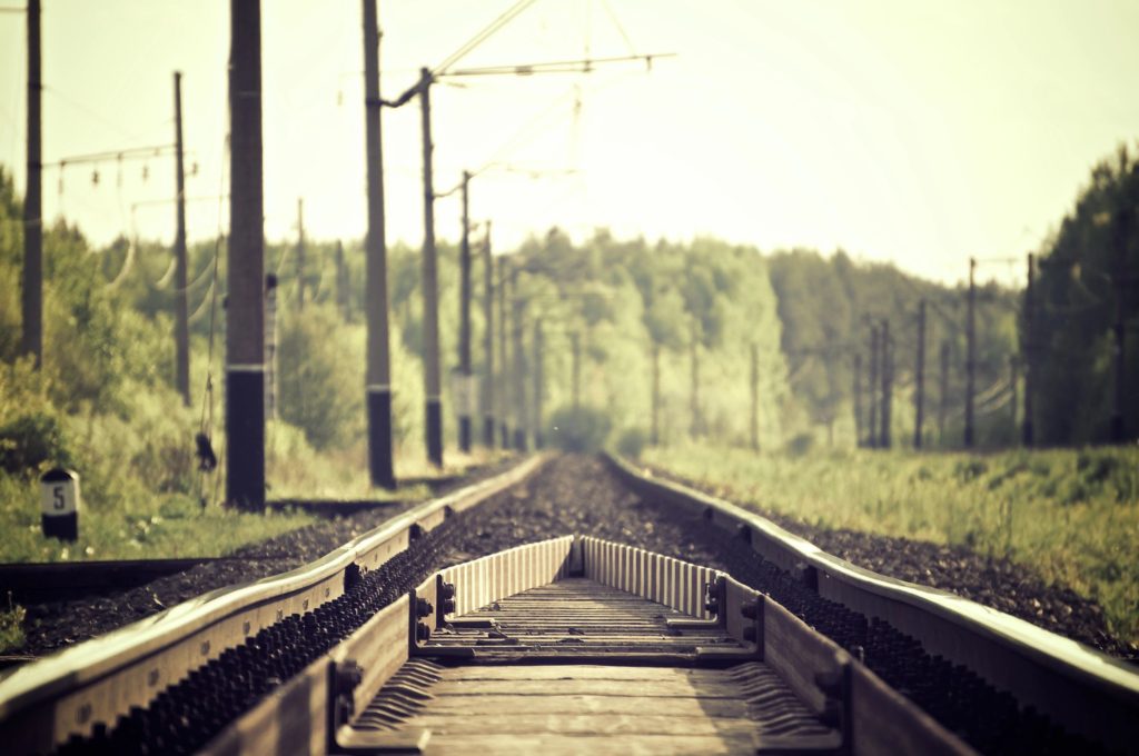 a railway track with trees all around