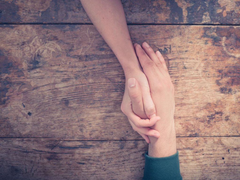 two people holding hands